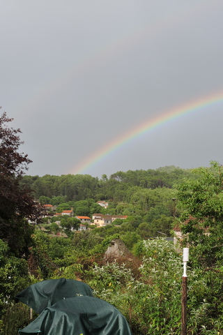 A summer shower produces a rainbow