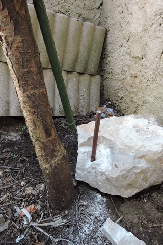Anchor stone and steel rod in place