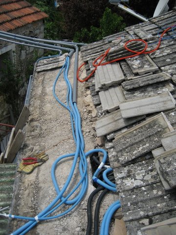 Wiring runs under the roof tiles