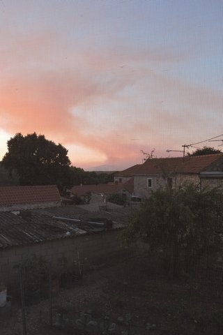 The setting sun turning the smoke pink